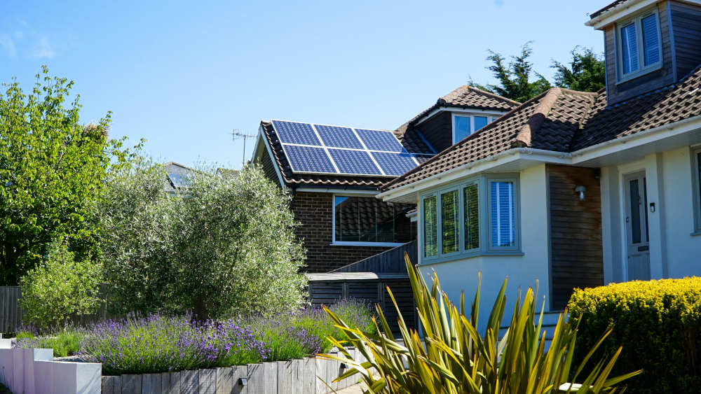 Solar panels on the roof of a house with very little fencing and protection. This would be a key example of a low risk, high reward house for solar panel theft