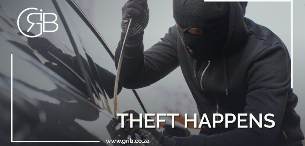 Car Theft Taking place. There is a man in a balaclava that is jimmying the car door open via the car window.
