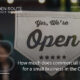 Yes We're Open" sign hanging in a small business shopfront window, representing commercial insurance cost for small businesses in the Garden Route